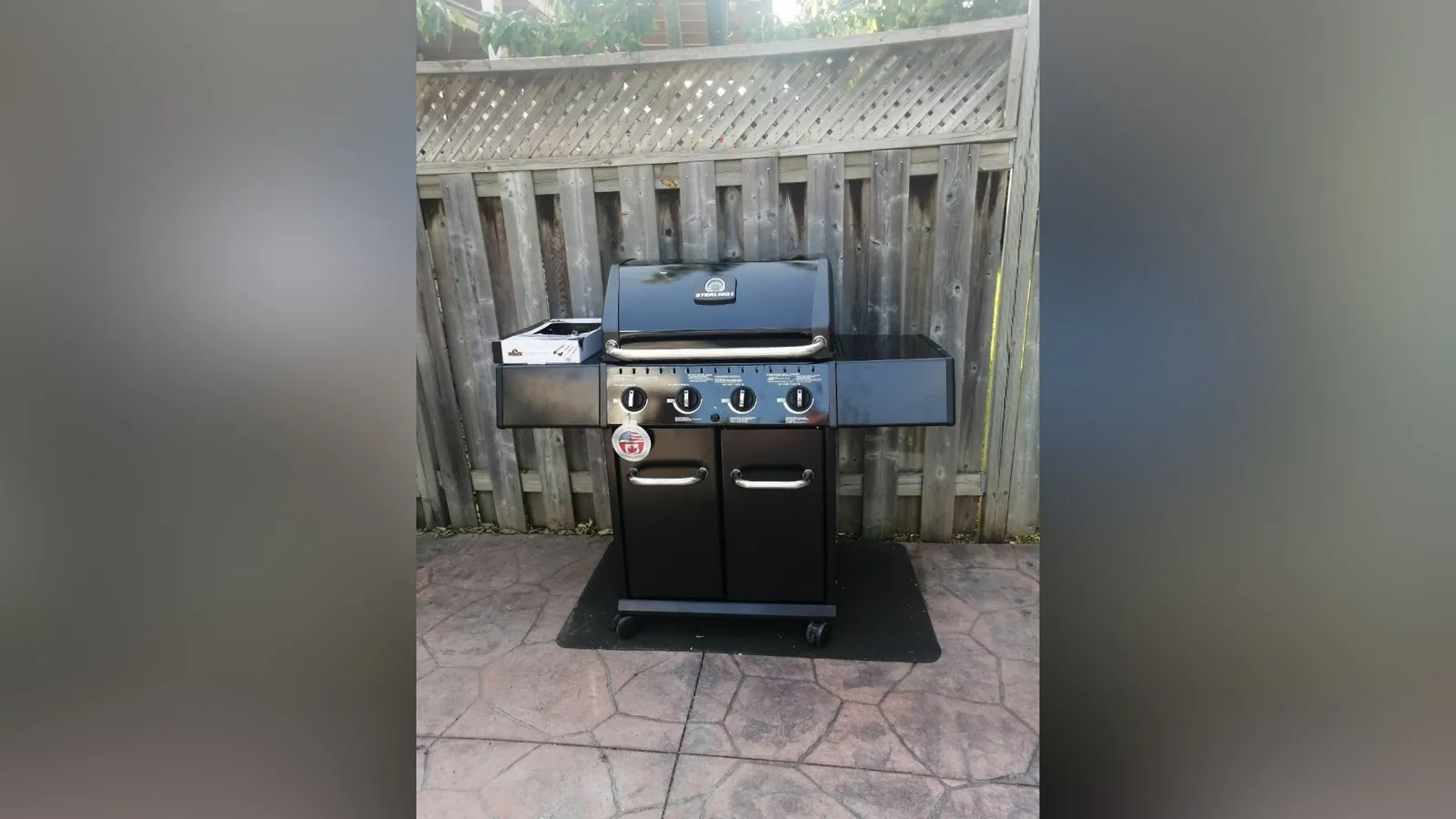 Gas barbecue assembled and levelled on a backyard patio