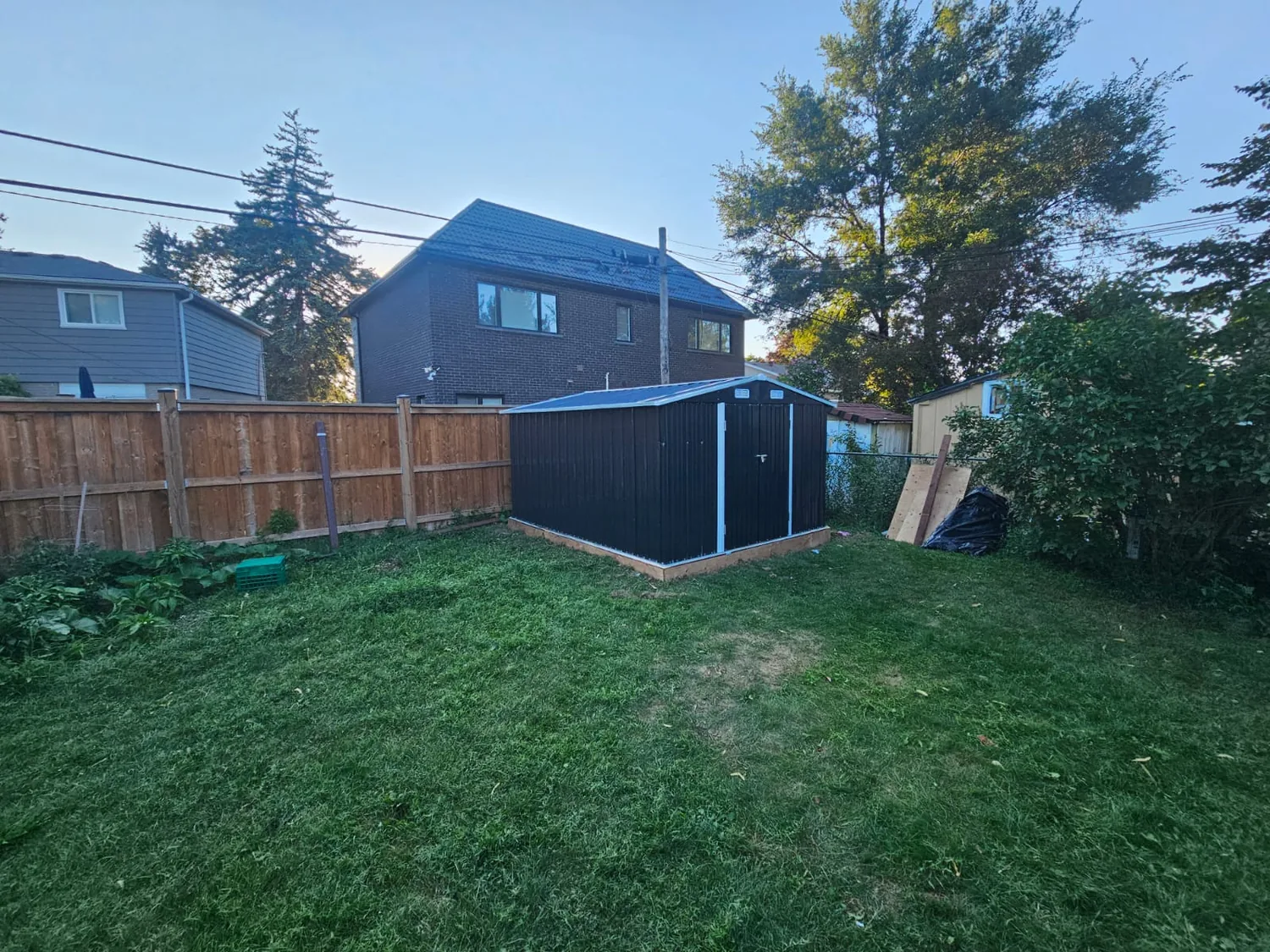 Metal shed on a wood base