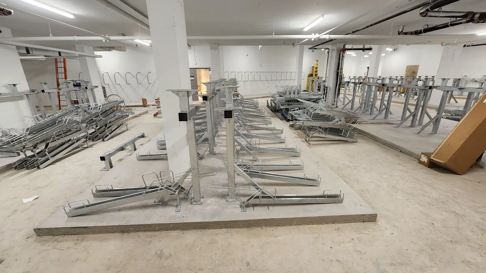 Vertical bicycle racks anchored into concrete slab