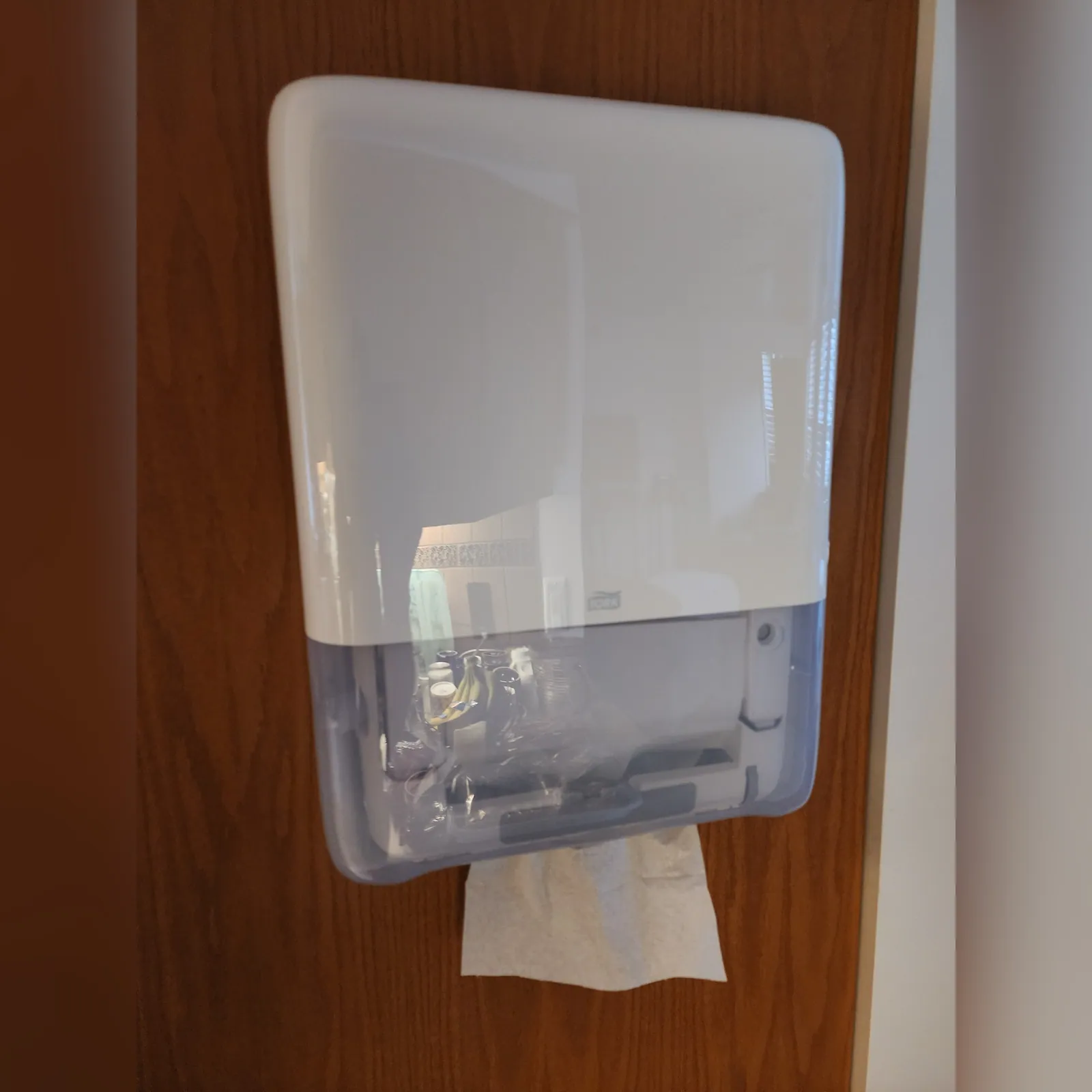 Soap dispenser mounted and sealed in a commercial washroom