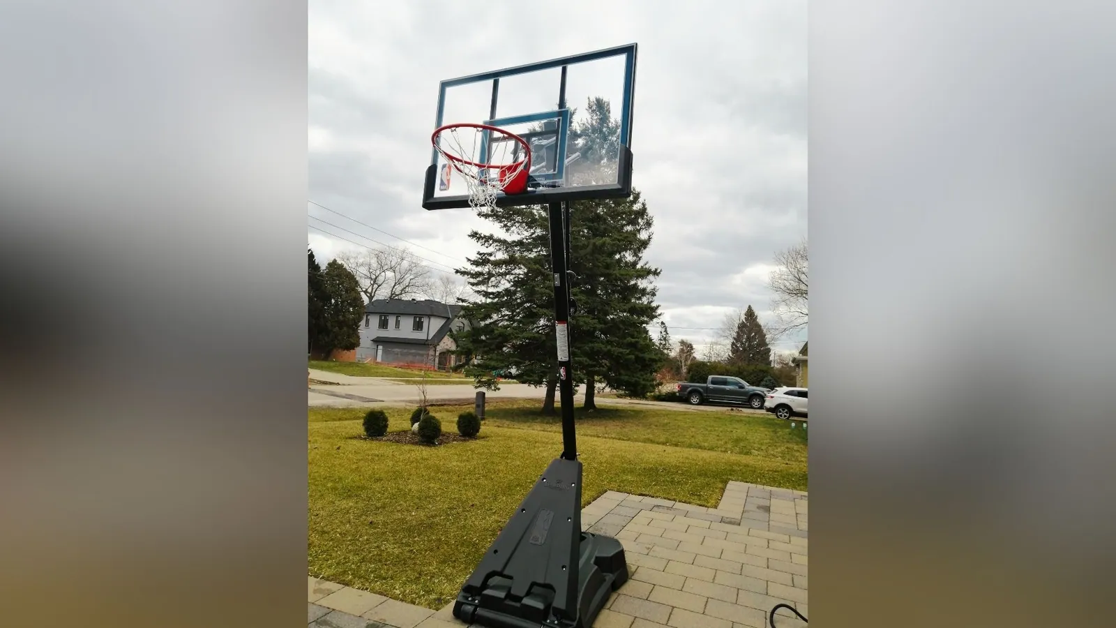 Basketball net installed and anchored on a driveway