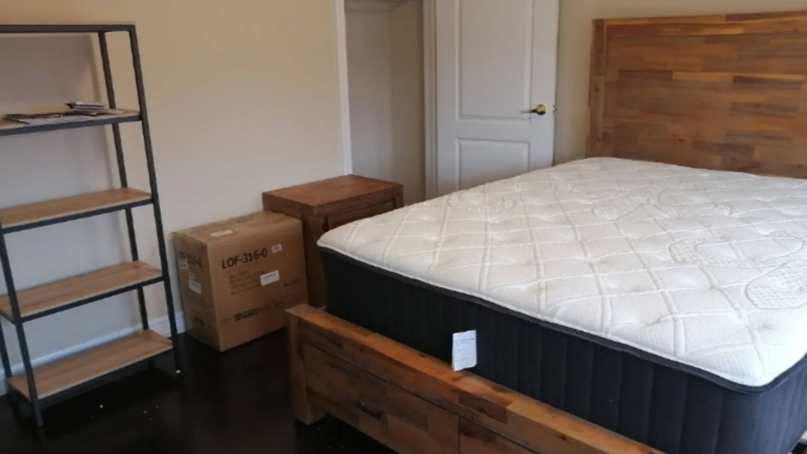Storage bed frame assembled and squared in a bedroom