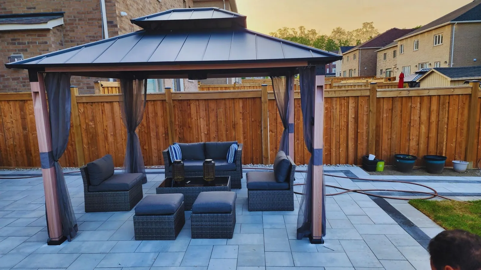 Hardtop gazebo assembled and anchored on a stone patio in the GTA