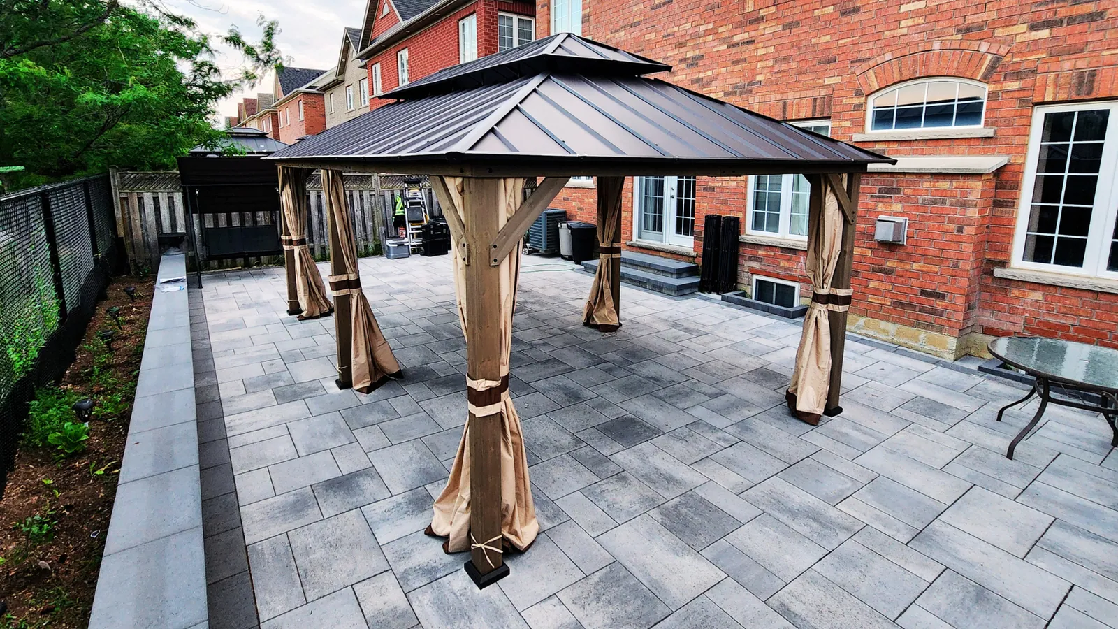 Gazebo with mosquito netting installed in a Brampton backyard