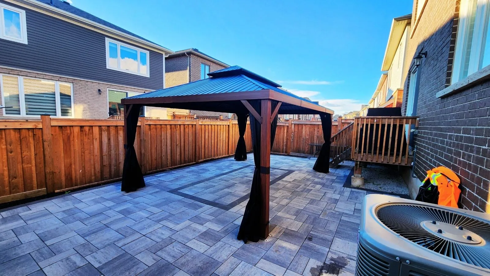 Gazebo with mosquito netting installed in a Brampton backyard