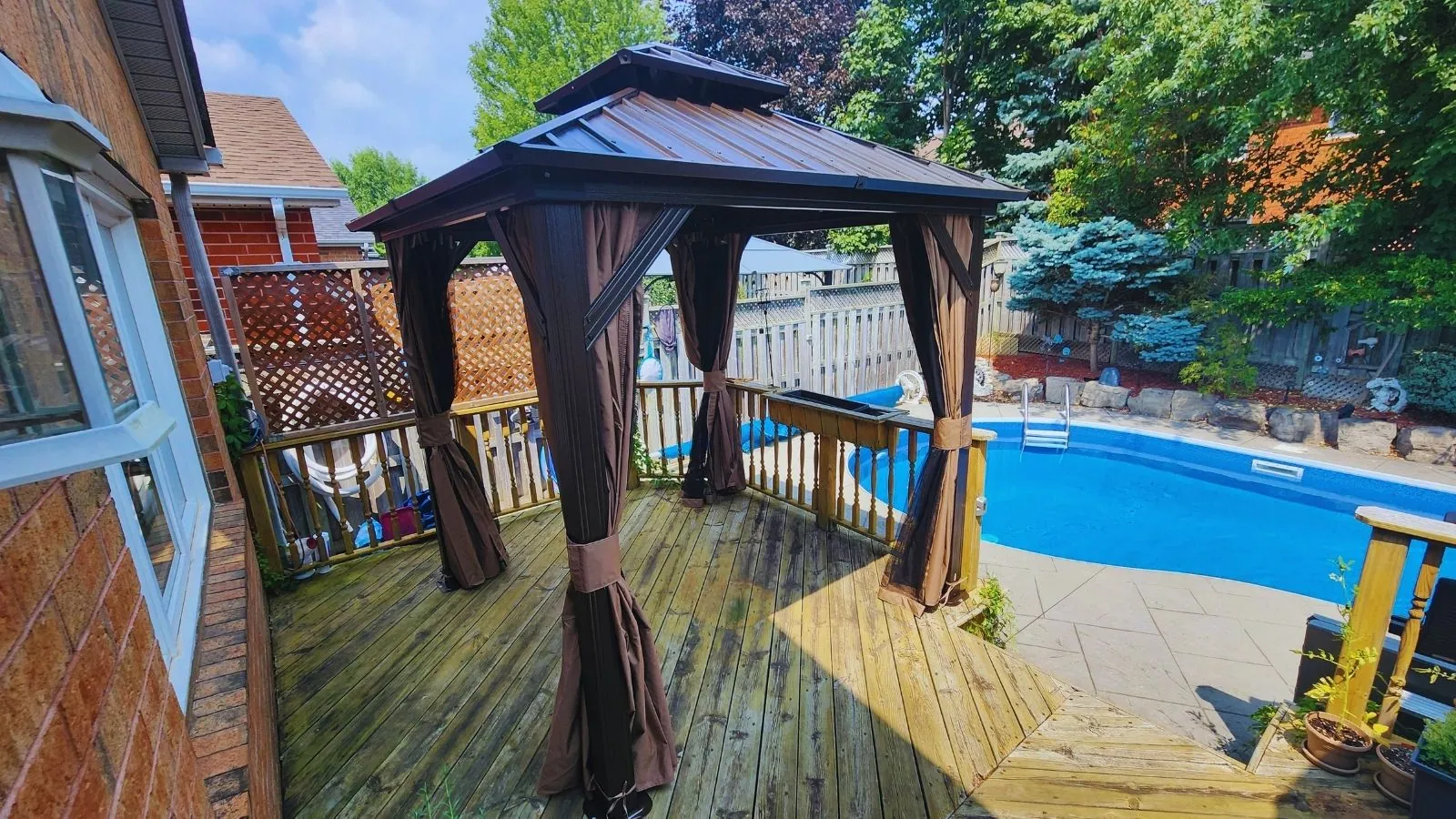 Hardtop gazebo assembled and anchored on a stone patio in the GTA