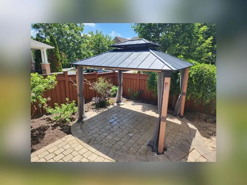 Gazebo with mosquito netting installed in a Brampton backyard