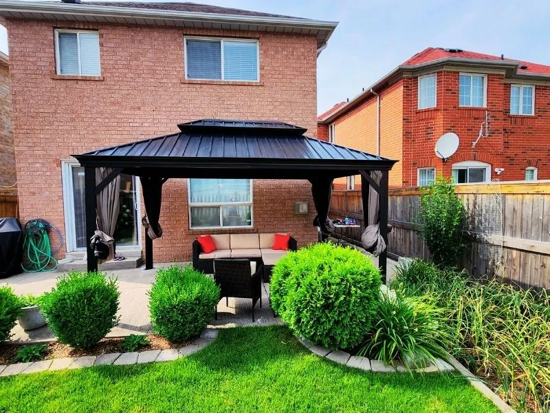 Double-roof hardtop gazebo anchored beside a swimming pool