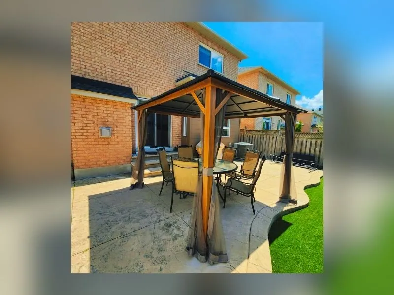 Hardtop gazebo assembled and anchored on a stone patio in the GTA