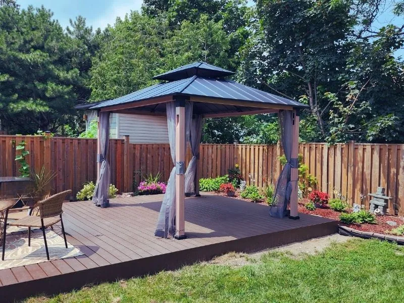 Cedar gazebo installed on a backyard deck by Helperama