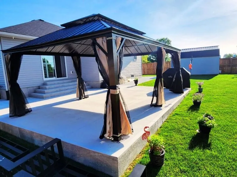 Double-roof hardtop gazebo anchored beside a swimming pool