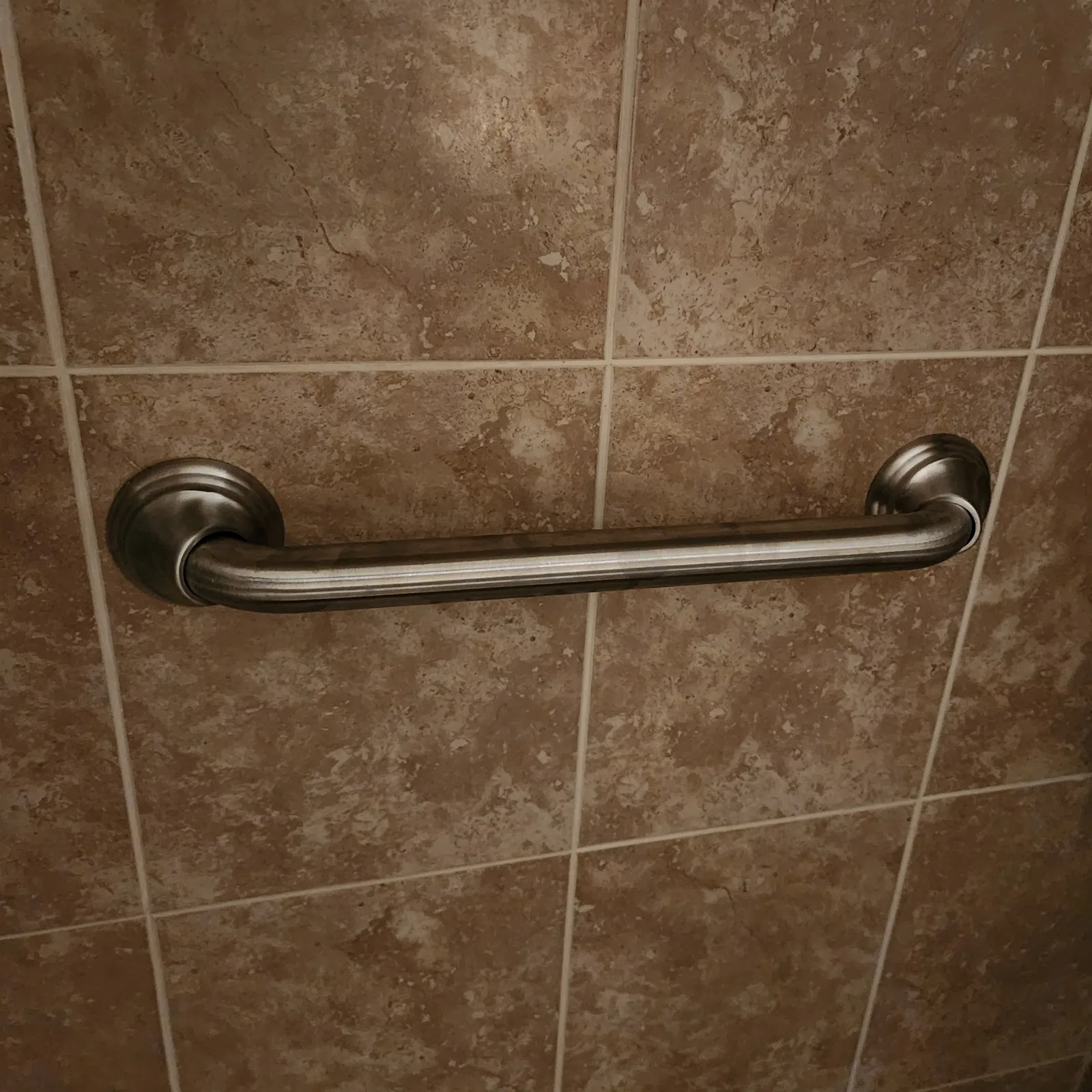 Grab bar installed beside a bathtub for safe entry