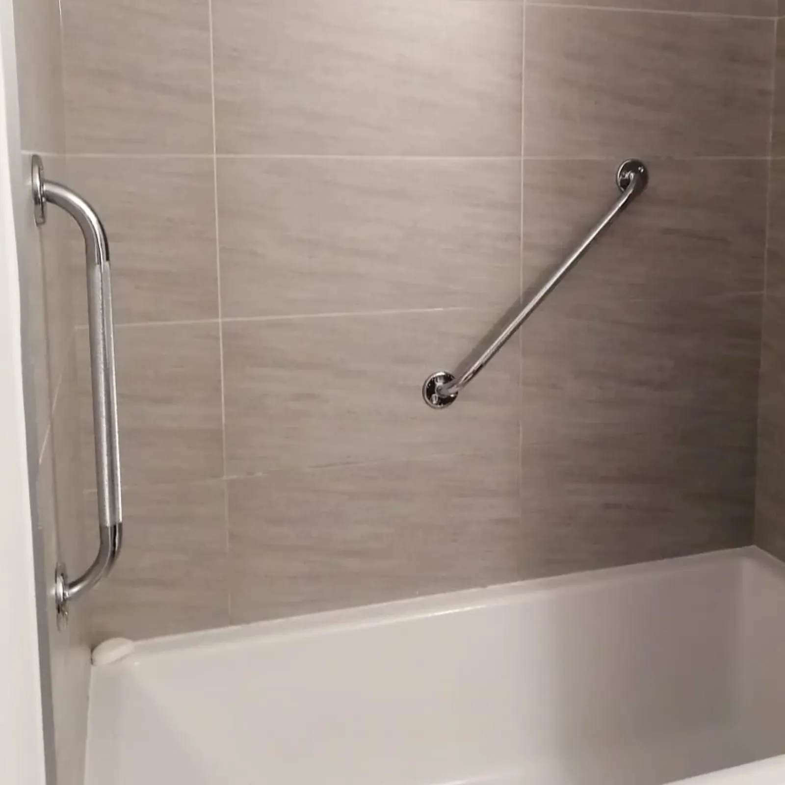 Angled grab bar mounted through tile without cracking