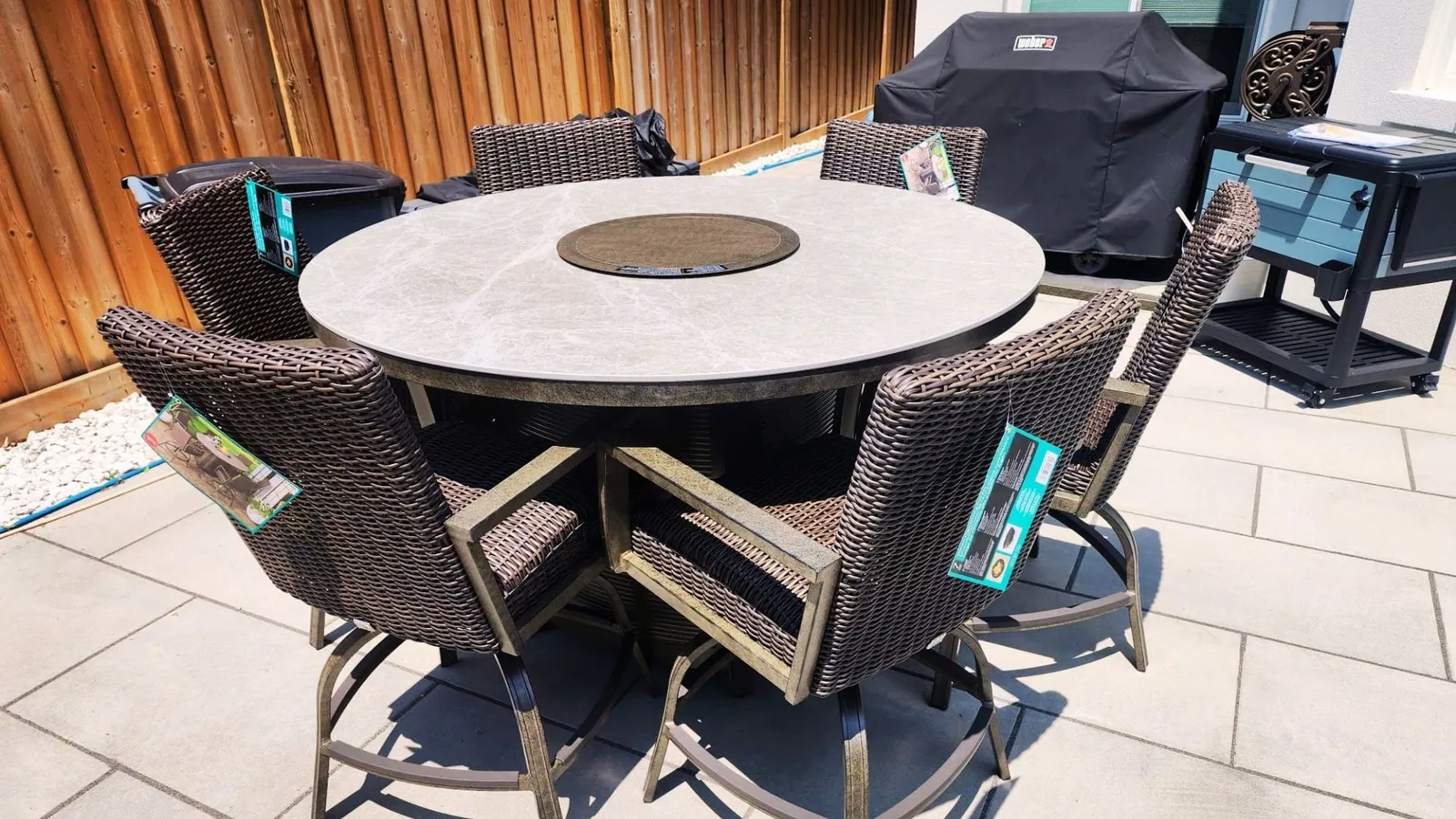 Patio dining set assembled on a backyard paver patio