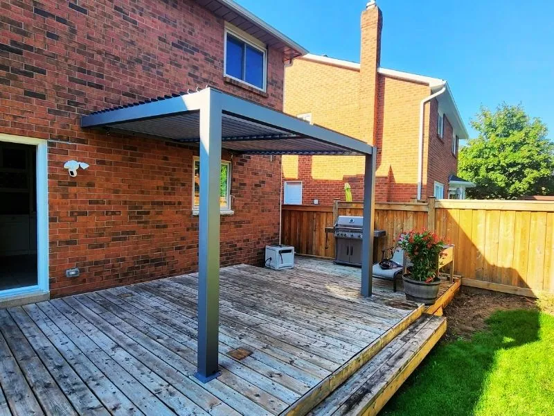 White wood pergola assembled over a paver seating area