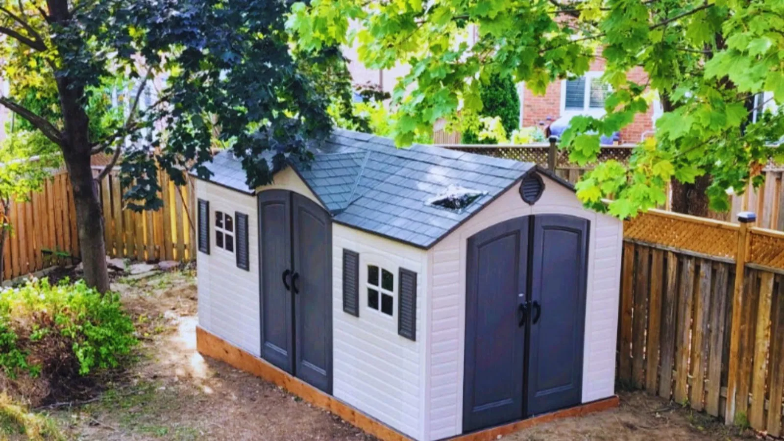 Garden shed installed against a fence line in the GTA