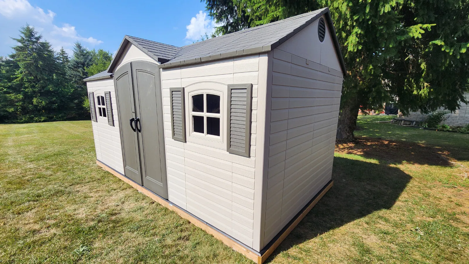 Backyard shed installed on patio stone by Helperama