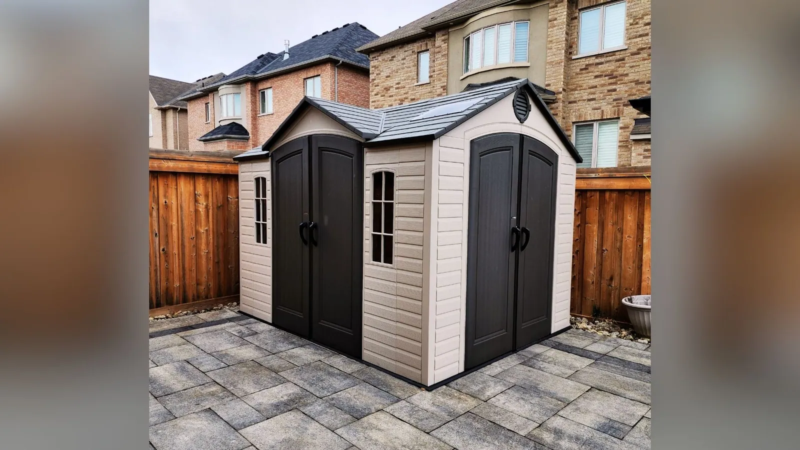Resin storage shed assembled level in a backyard