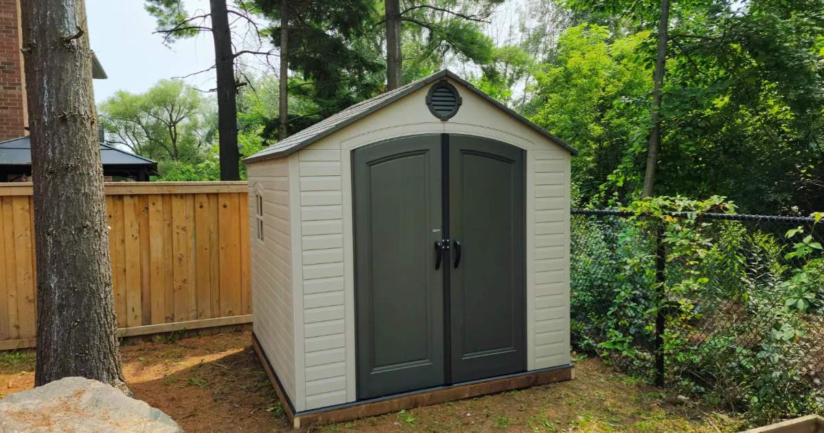 Vinyl shed built on a prepared base with doors aligned