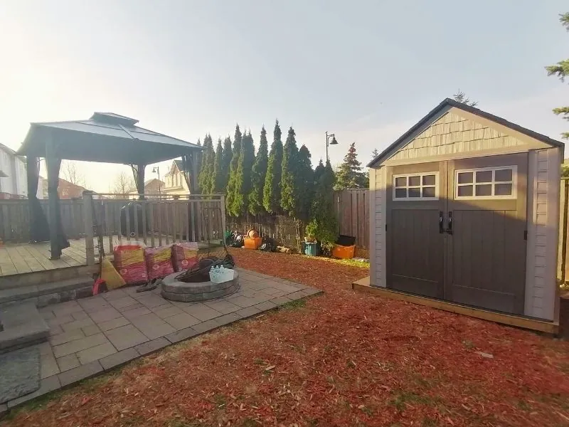 Garden shed installed against a fence line in the GTA