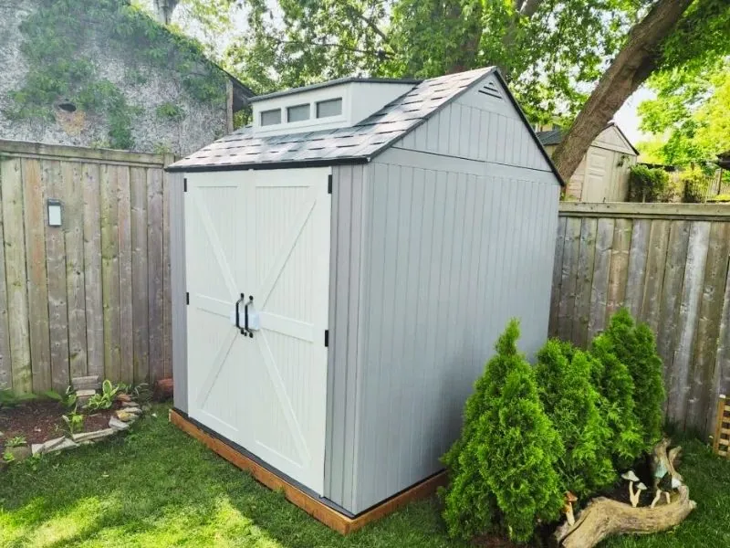 Backyard shed installed on patio stone by Helperama