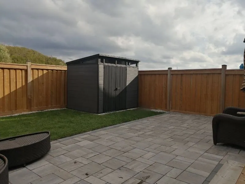 Resin storage shed assembled level in a backyard