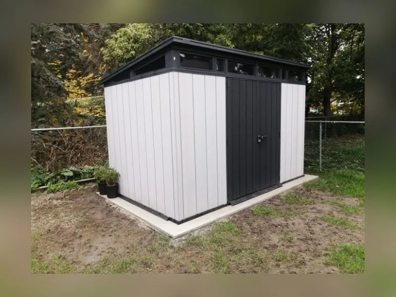 Vinyl shed built on a prepared base with doors aligned
