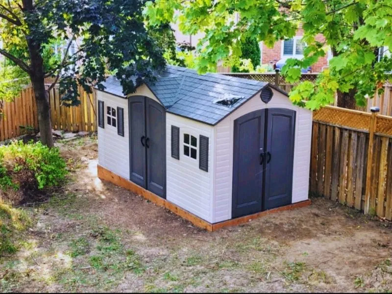 Garden shed installed against a fence line in the GTA