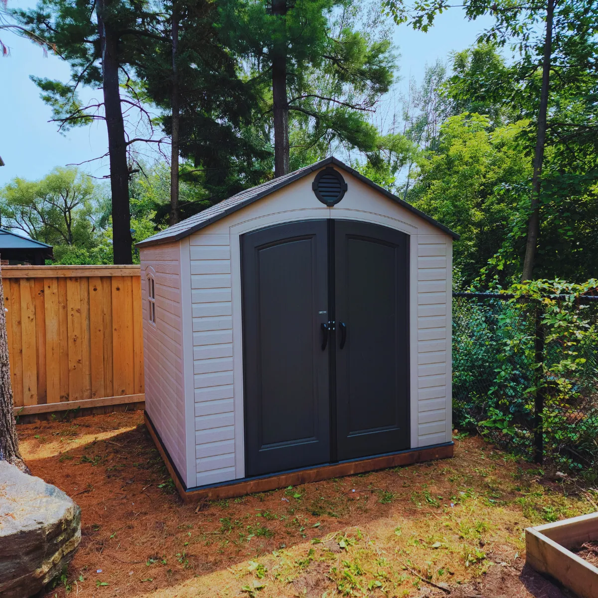 Vinyl shed built on a prepared base with doors aligned