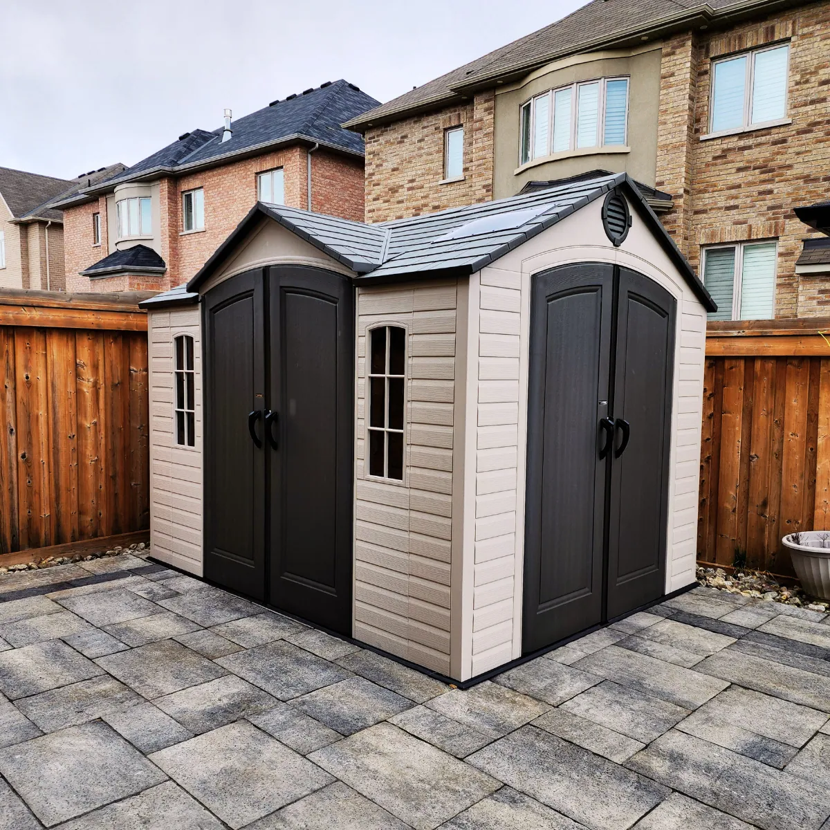 Garden shed installed against a fence line in the GTA