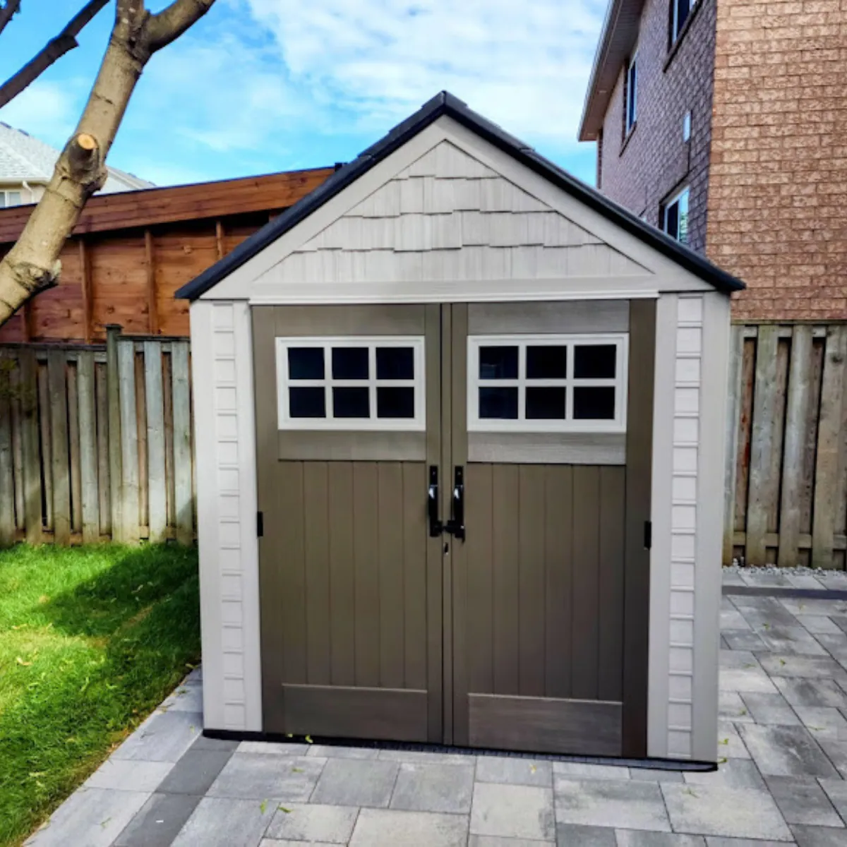 Backyard shed installed on patio stone by Helperama
