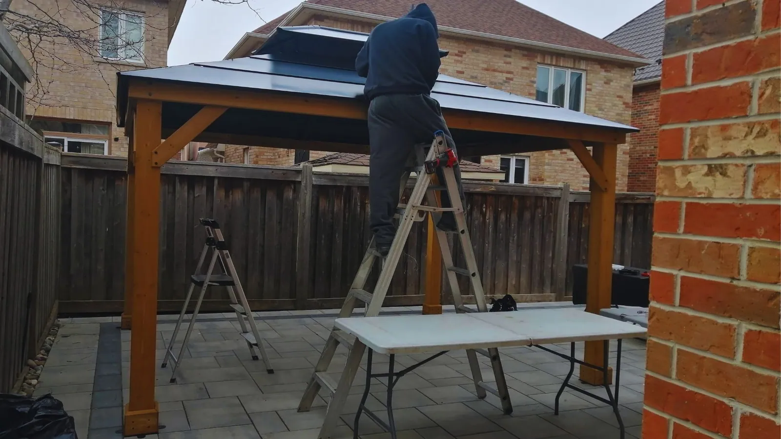 Crew member fitting a TV wall mount