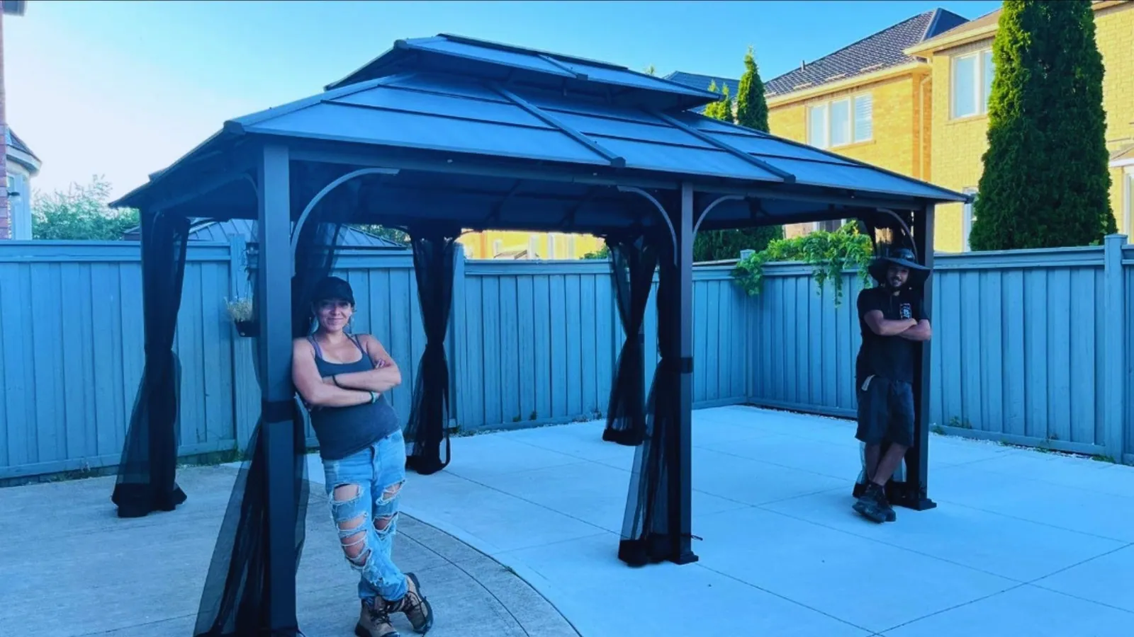 Crew member carrying a cedar beam on a gazebo build
