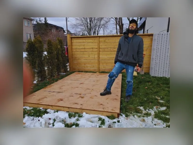 Installers fitting a gazebo roof from ladders