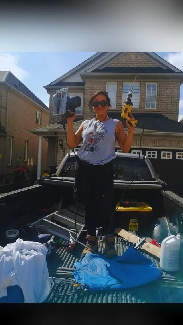 Helperama co-owner in the truck bed with the tools for the day