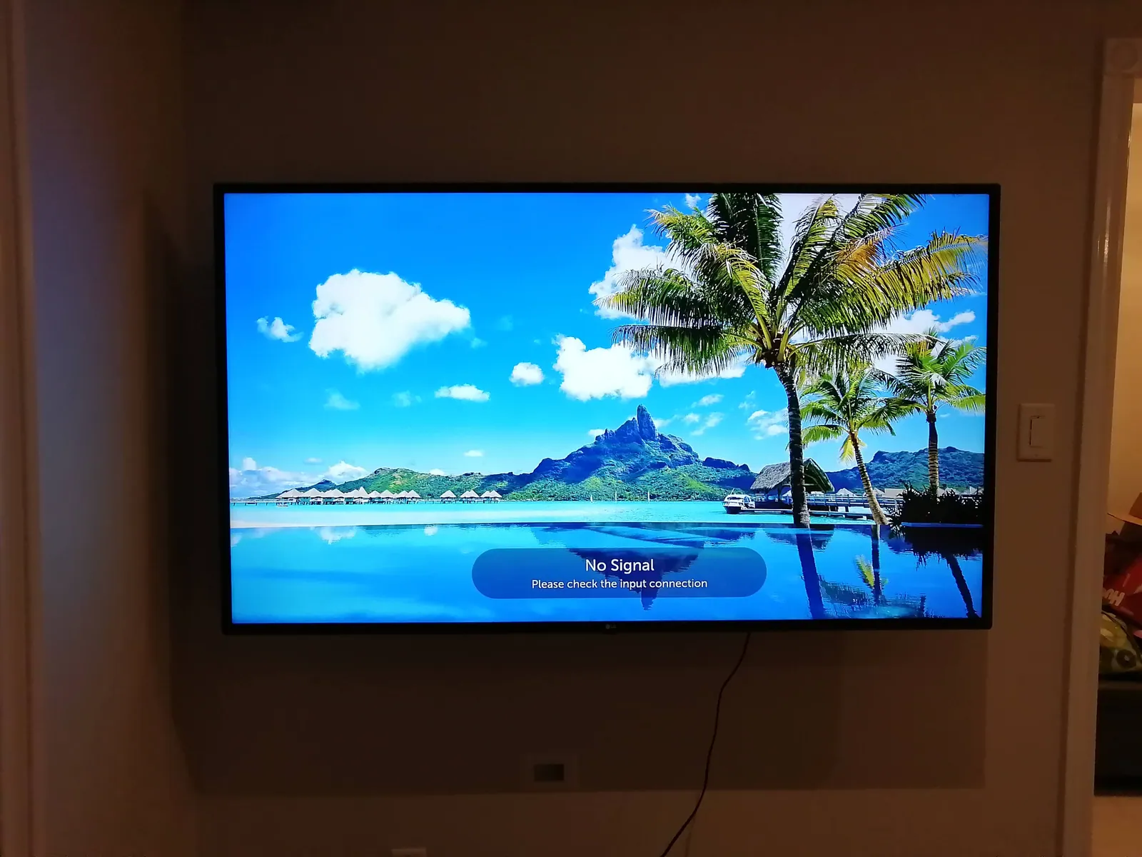 Flat-screen TV mounted level on a living room wall